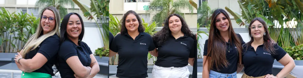 Grupo de mulheres colaboradoras posando lado a lado em área externa com vegetação ao fundo, demonstrando confiança e proximidade.